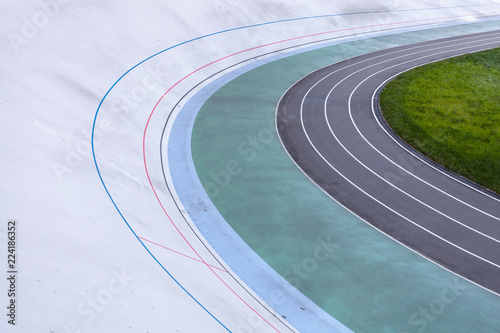 Activity, athletics concept. High angle top view cropped photo of new empty modern bicycle asphalt track in the open air with multicolored paths for playing sports