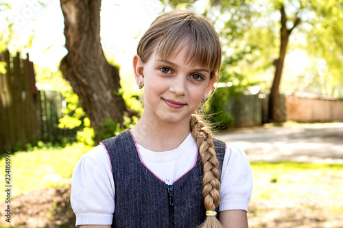 Portrait of a teenage girl, in strict clothing.  The girl in the park