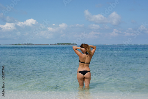 Pretty girl in bikini taking sun in amazing beach of Maldives islands © JosManuel
