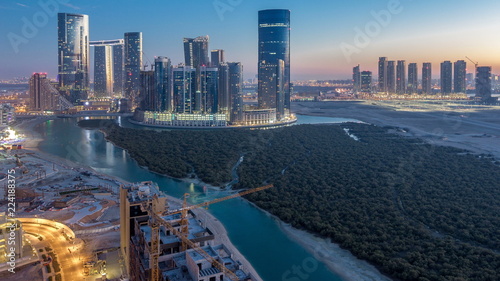 Buildings on Al Reem island in Abu Dhabi day to night timelapse from above. photo