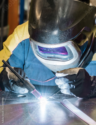 Metal welding process that uses a non-consumable tungsten electrode. Close-up. photo