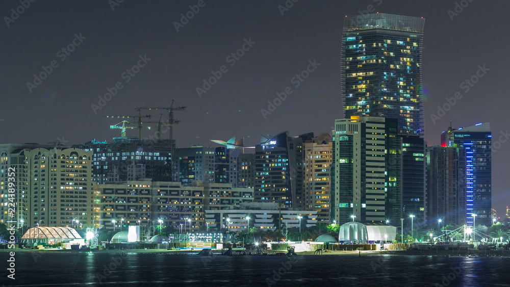 Panorama view of Abu Dhabi Skyline and seafront at night timelapse, United Arab Emirates