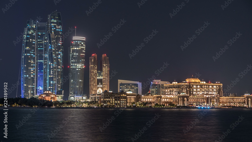Skyscrapers of Abu Dhabi at night with Etihad Towers buildings timelapse.