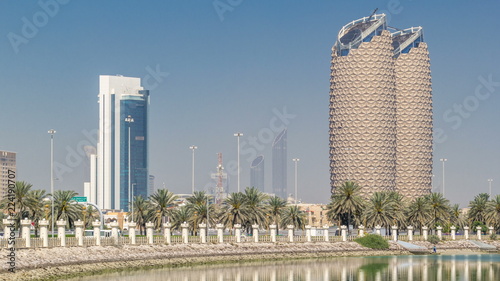 View of skyscrapers skyline with Al Bahr towers in Abu Dhabi timelapse. United Arab Emirates
