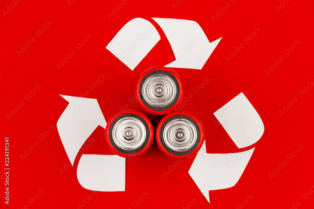 Huge white recycle reuse sign symbol with old used circle round flat  alkaline lithium cell batteries on red warning background. Eco ecology  environment batteries recycling reuse concept Stock Photo | Adobe Stock