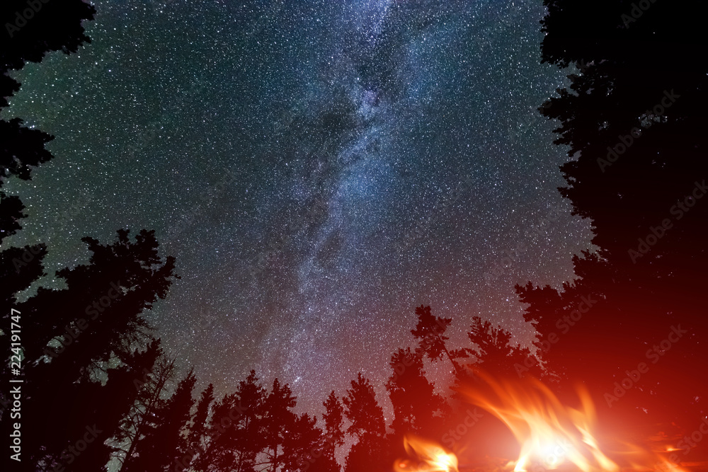 Milky Way Galaxy in sky and campfire - obrazy, fototapety, plakaty 