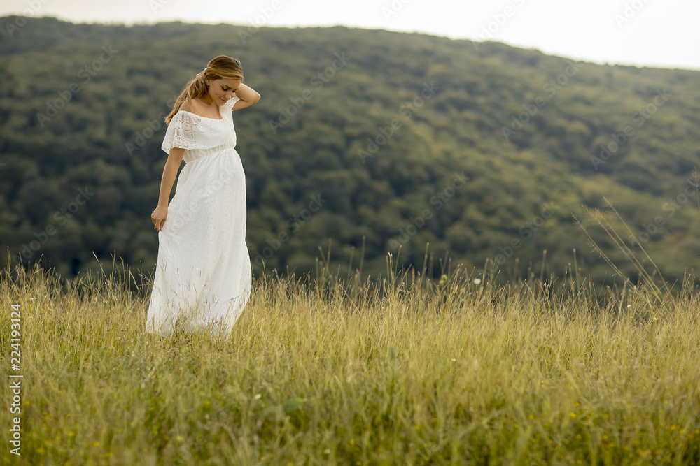 Young pregnant woman relaxing outside in nature Young pregnant woman relaxing outside in nature