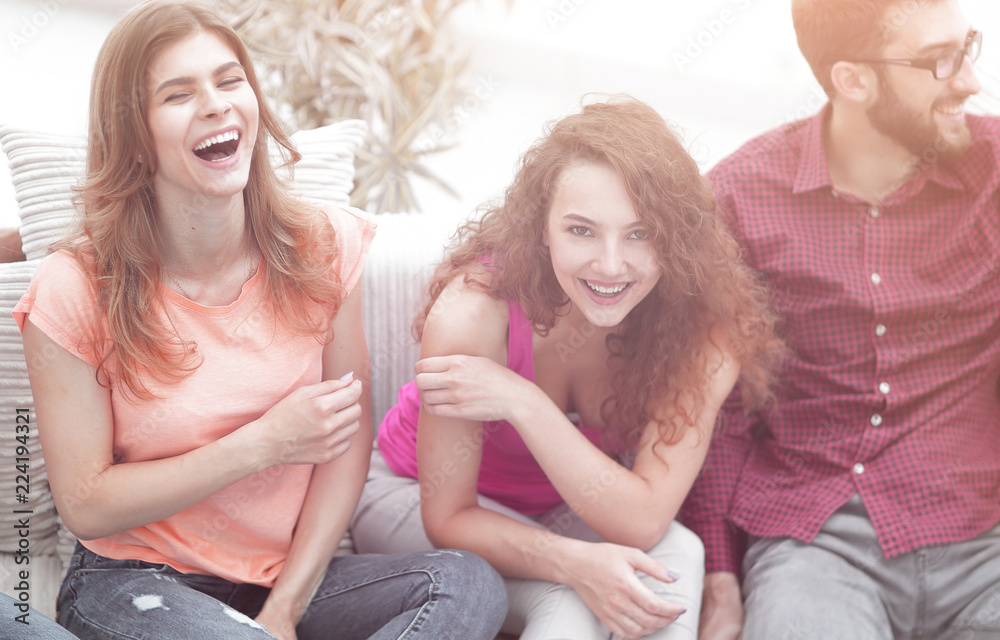 cheerful friends laughing in the living room. cheerful friends laughing in the living room.