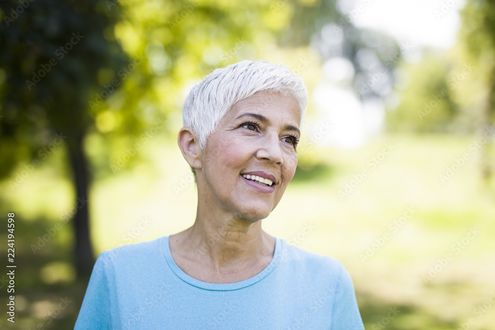 Portrait of a smiling sporty senior woman in a park Portrait of a smiling sporty senior woman in a park