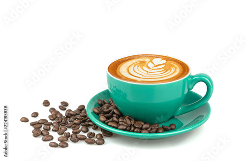 Side view of hot latte coffee with latte art and roasted coffee beans in a green cup isolated on white background.