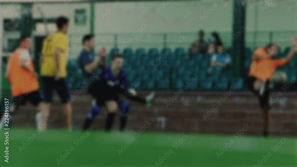 Goalkeeper not save a ball and misses goal, soccer player hits the ball and scores a goal, football championship, blurred for background Goalkeeper not save a ball and misses goal, soccer player hits the ball and scores a goal, football championship, blurred for background