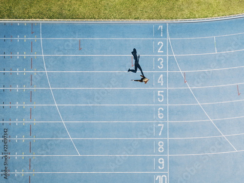Fototapeta Naklejka Na Ścianę i Meble -  Track and field track with sprinter in overhead shot