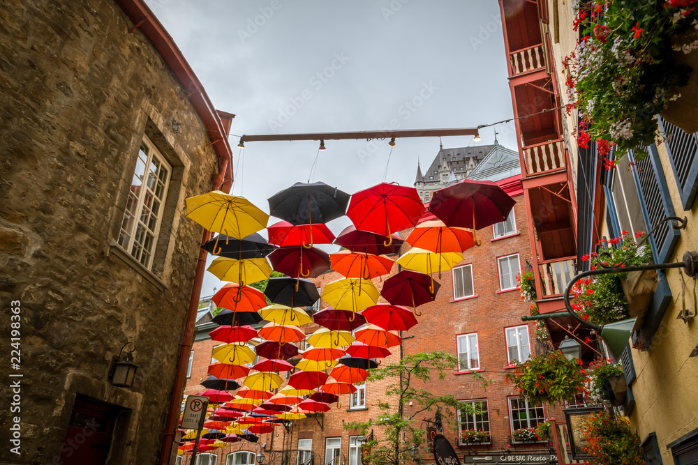 Fototapeta premium QUEBEC CITY, QUEBEC / CANADA - JULY 14 2018: Colorful umbrellas on city street