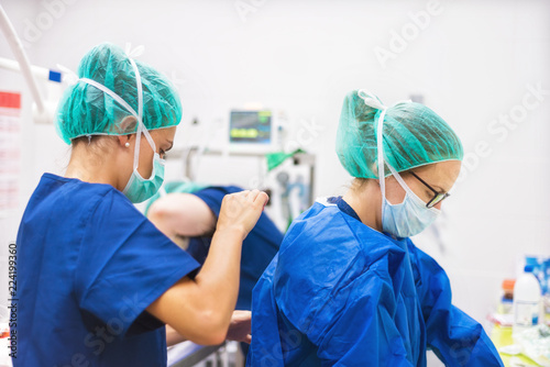 Surgeon and assistant preparing for surgery