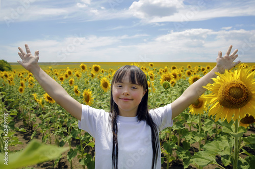 Little girl in sunflowers field photo