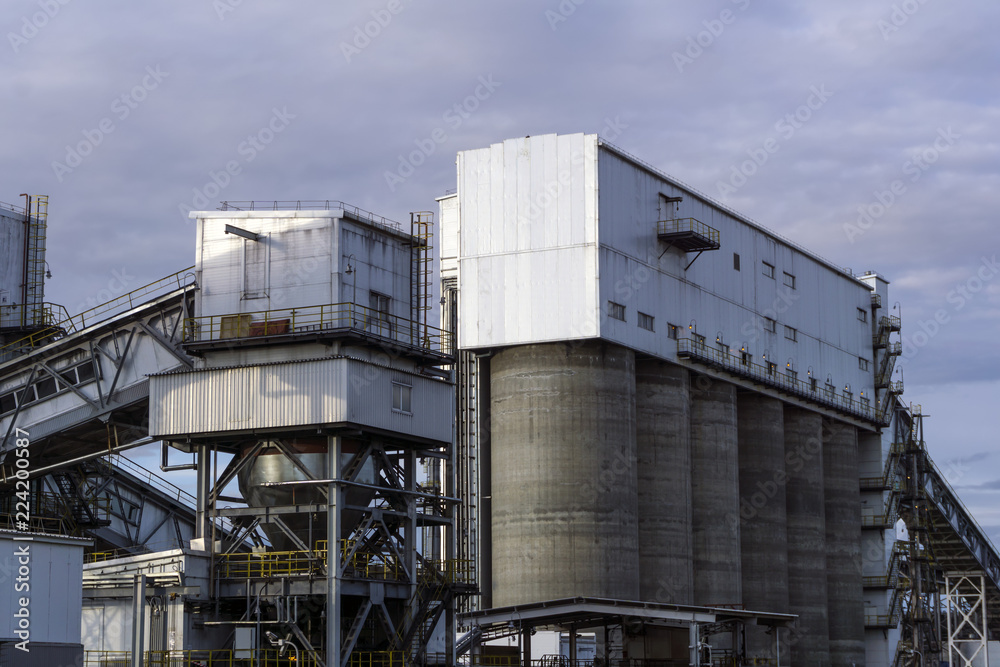 Industrial landscape - storage and loading hopper for loose materials with inclined conveyor galleries