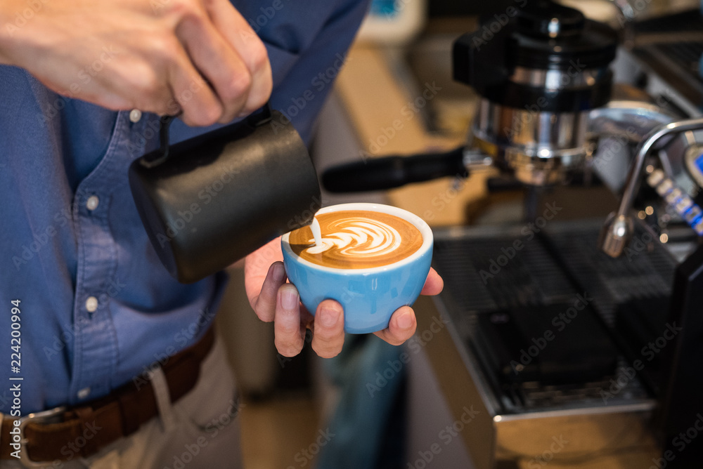 Barista making coffee latte art