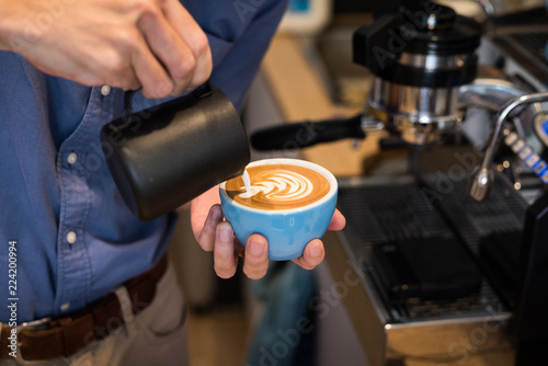 Barista making coffee latte art
