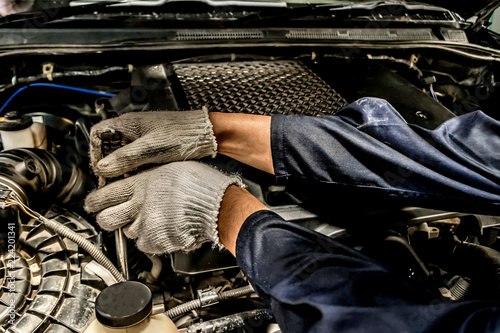 People are repair a car Use a wrench and a screwdriver to work.Safe and confident in driving. Regular inspection of used cars. It is very well done.