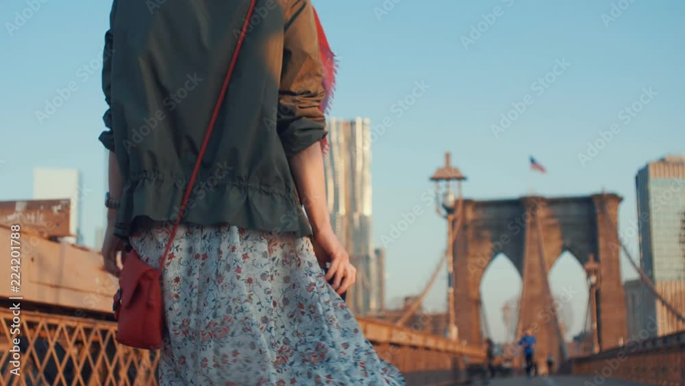 Young girl with a retro camera on the bridge