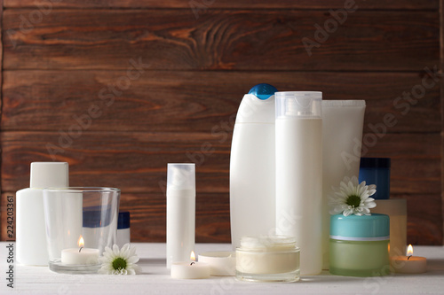 Canvas Print a set of usurious cosmetics, a towel and a candle on a wooden background