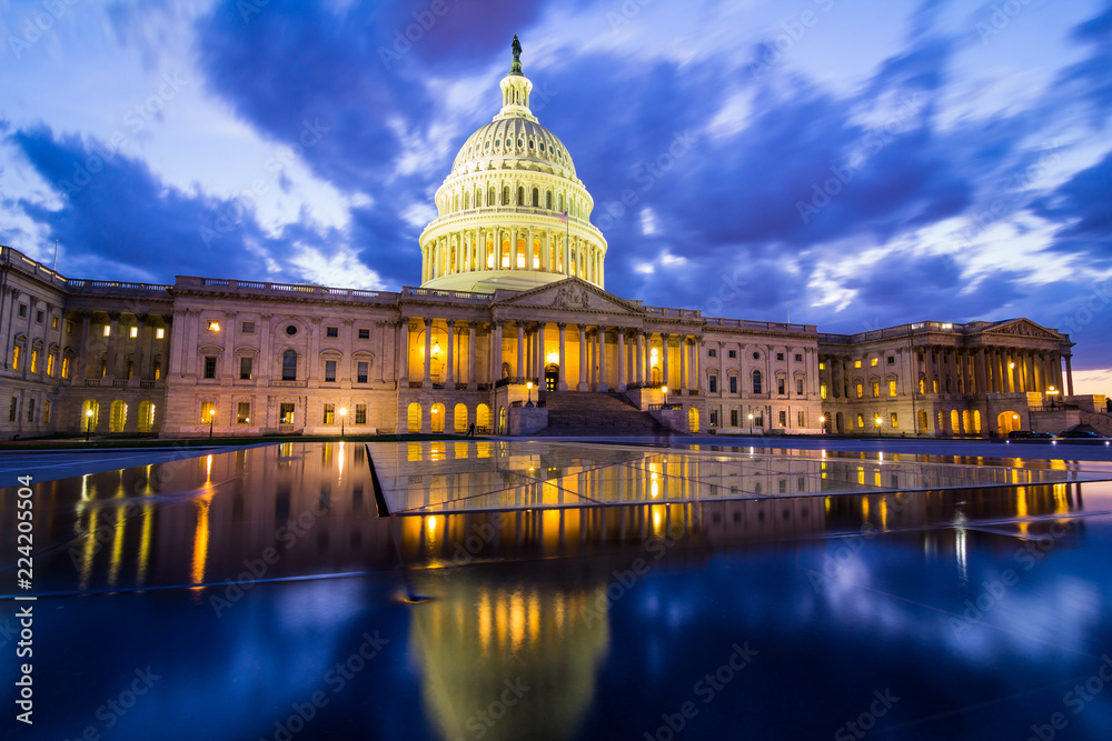 The US Capitol in Washington DC at nightfall with dramatic clouds