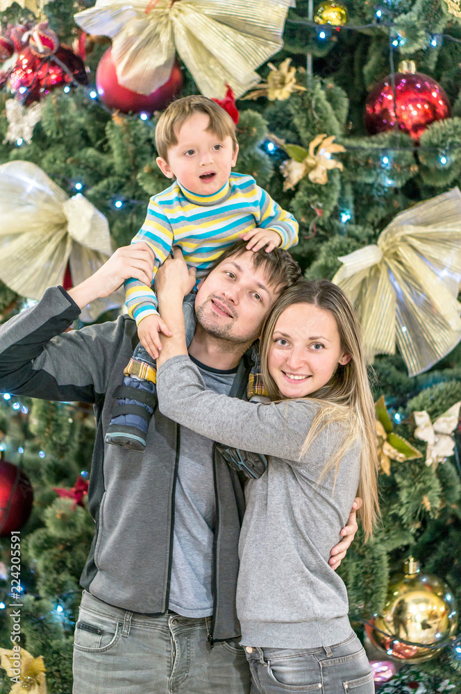 Smiling happy family having fun with Christmas presents at home