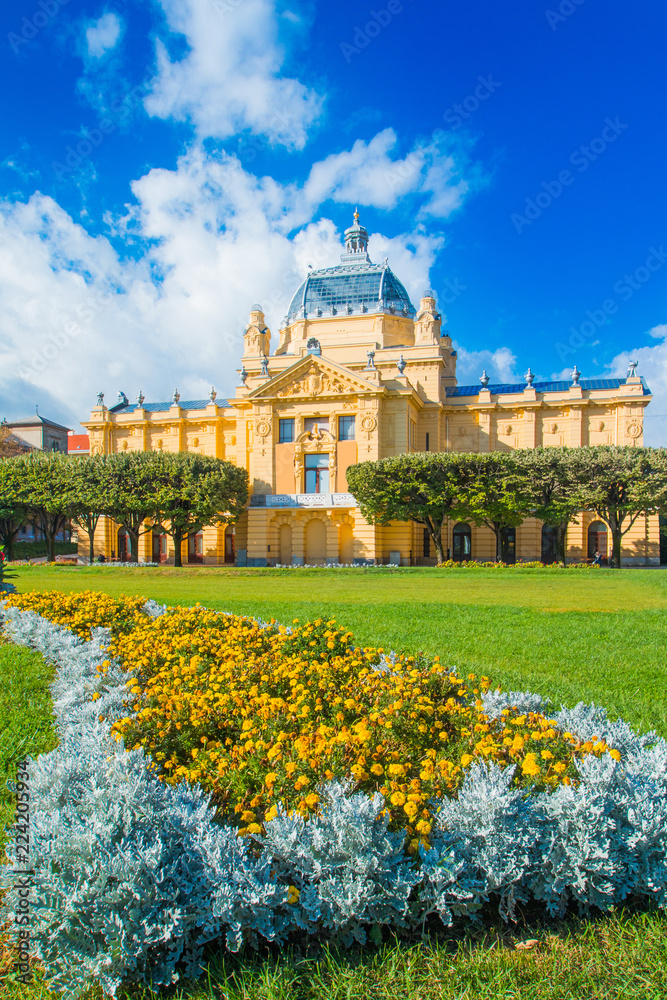      Zagreb, Croatia, art pavilion and beautiful flowers in park in summer day, colorful 19 century architecture 