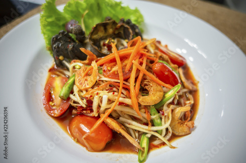 Thai food SOM TUM papaya salad with spicy garnish 