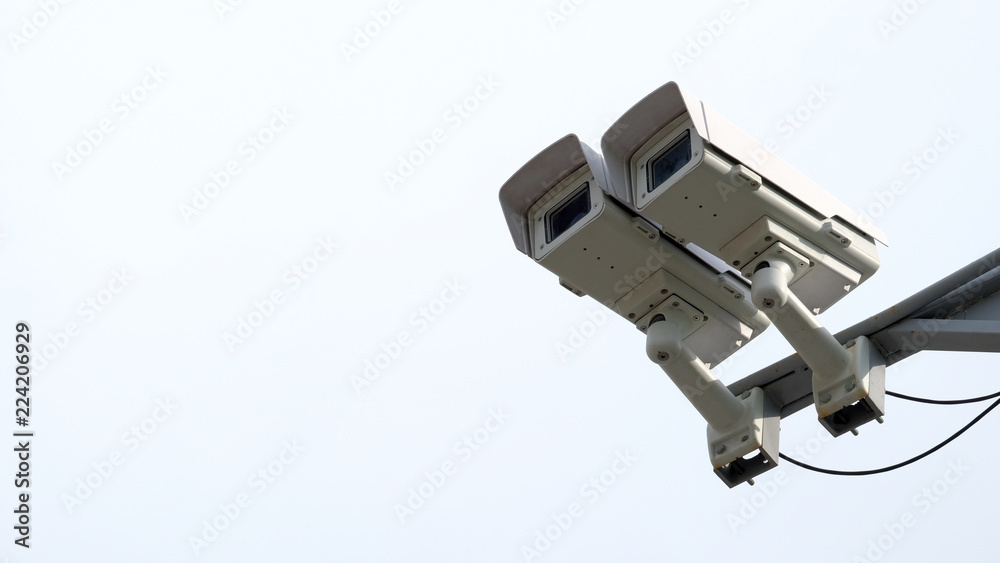 On the pillar stay two cameras in the right of the frame. Close - up. Control of video surveillance. The concept of road safety. On the pillar stay two cameras in the right of the frame. Close - up. Control of video surveillance. The concept of road safety.