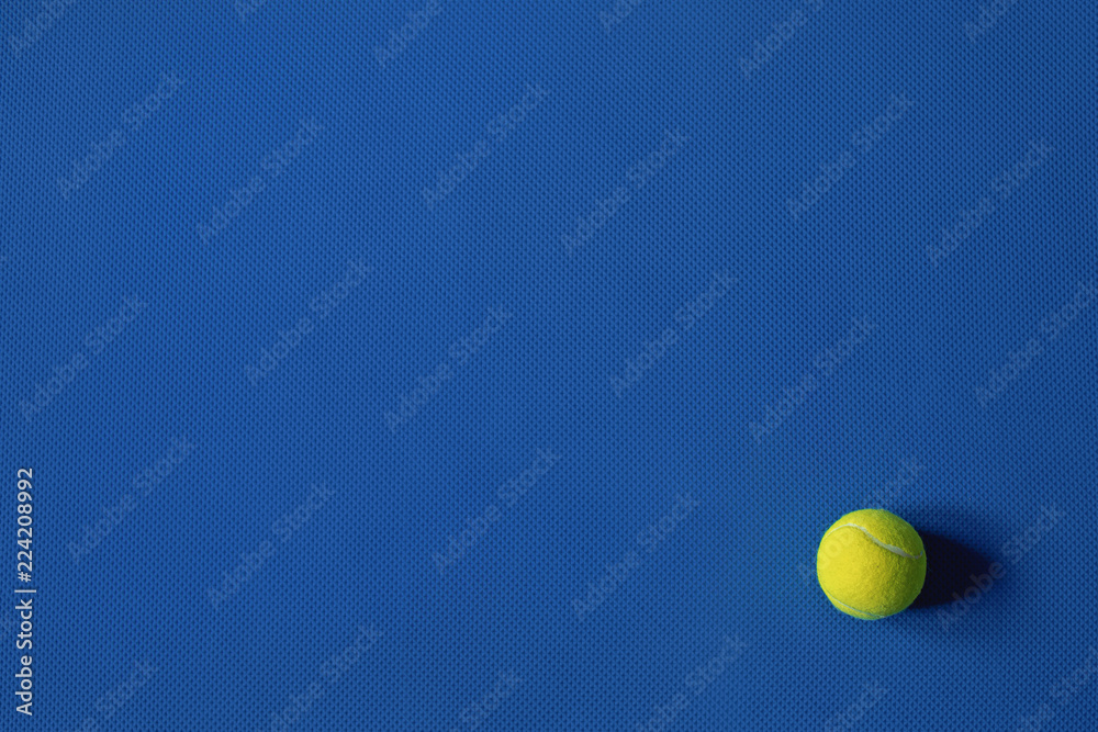 Yellow tennis ball on the blue background