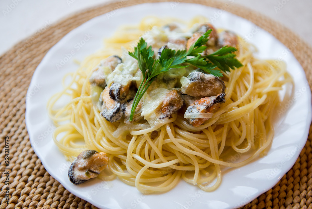 Traditional italian seafood pasta with clams. Spaghetti with mussels in creamy sauce Traditional italian seafood pasta with clams. Spaghetti with mussels in creamy sauce