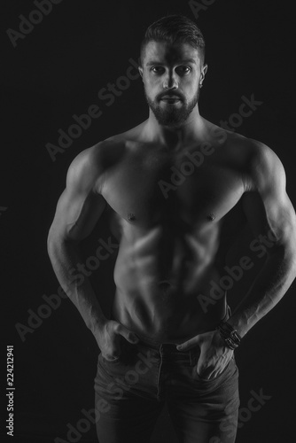 Athletic Strong Sexual Man Abs Six Pack Muscles Bodybuilding And Fitness Concept. Studio shot, Low key, copy space on black background
