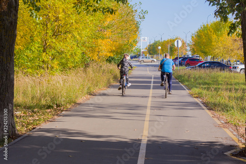Izhevsk, Russia, 24.09.2018, teenage boys ride bicycles on sidewalks