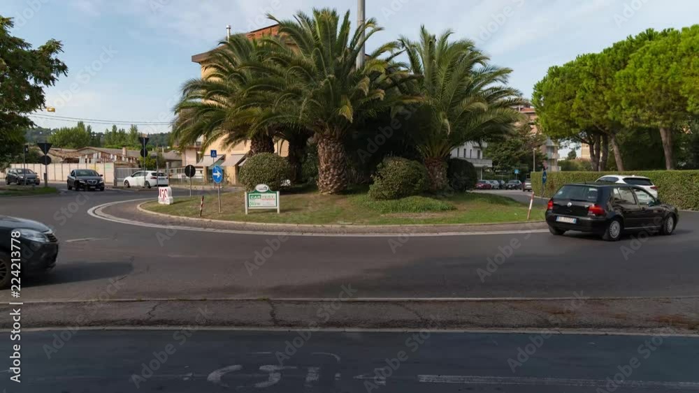 Cars ride by roundabout on an italian Square Cars ride by roundabout on an italian Square