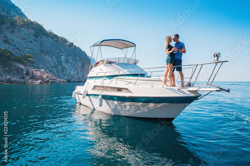 Couple on a Yacht. Luxury vacation on the Boat young man and woman. Sailing the Sea.