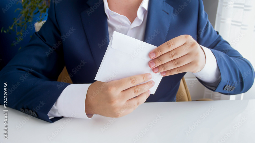 Obraz premium Closeup image of bribed politician holding envelope with money