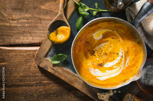 Autumn pumpkin creamy soup in pot photo