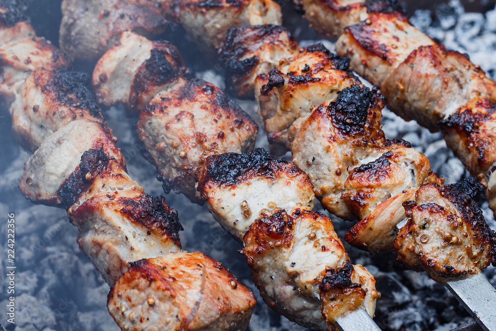 Barbecue on the grill. Shashlik made of cubes of meat on the skewers during of cooking on the mangal over charcoal