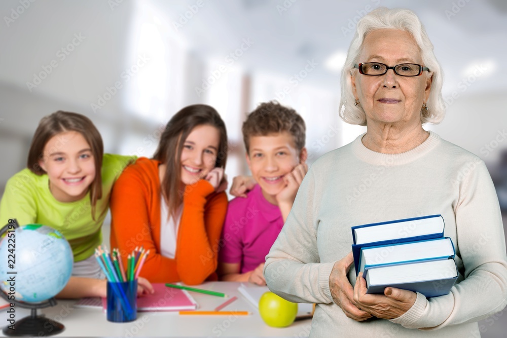 Young female teacher with students in classroom Young female teacher with students in classroom