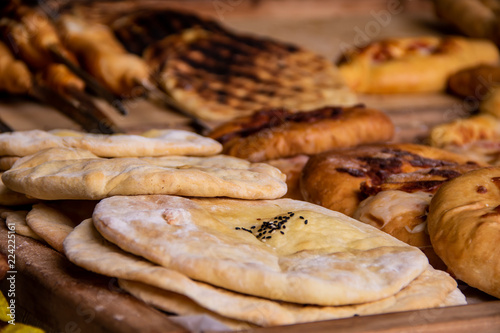 Baked flat bread lavash with spices and various fudges in the background photo