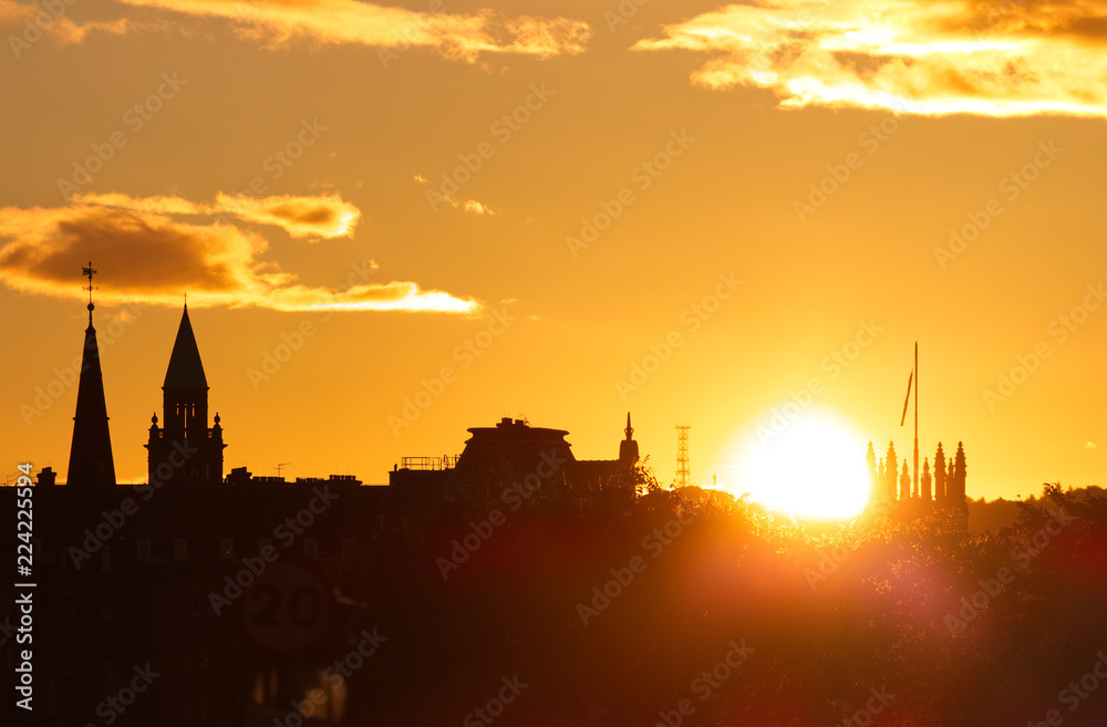 A shot of the setting sun over the Edinburgh skyline in Scotland. 