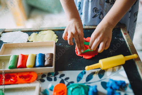 girl playing with pla dough at home photo