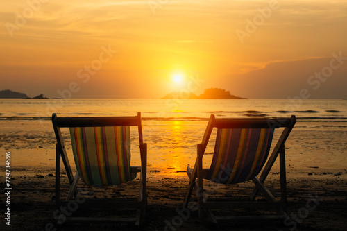 Sun loungers on the sea beach during sunset. © De Visu