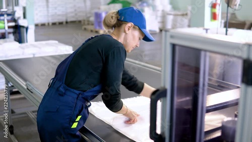 woman worker in the production of plastic packaging folds finished products