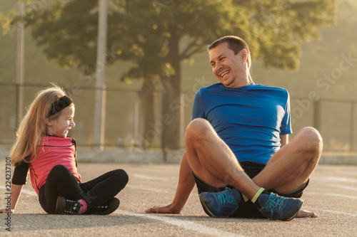 Dad and daughter go in for sports.Dad and daughter at the stadium.