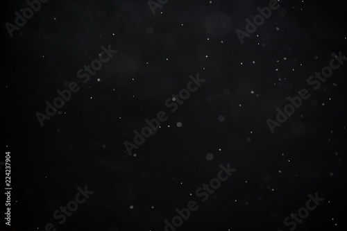 Snowfall on black background - design element. Abstract black white snow texture on black background for overlay