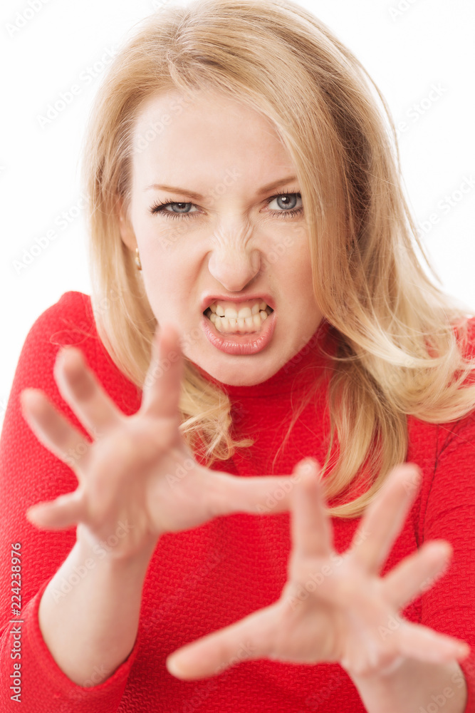 Beautiful woman with an angry expression, close-up, isolated on a white background Beautiful woman with an angry expression, close-up, isolated on a white background