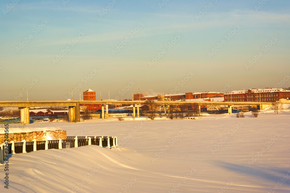 Obraz premium View of the Kostroma River, the bridge and the left bank in a winter sunny day.Costroma. Russia.