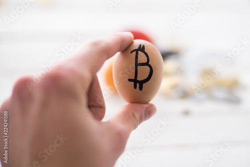 Egg with logo bitcoin in hand. The concept of Crypto-currency photo